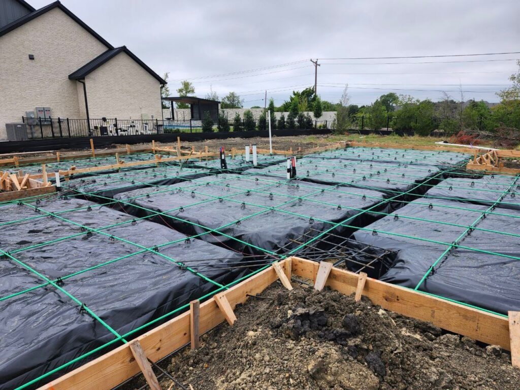 Post-tension tendons and grade beams laid before a slab is poured